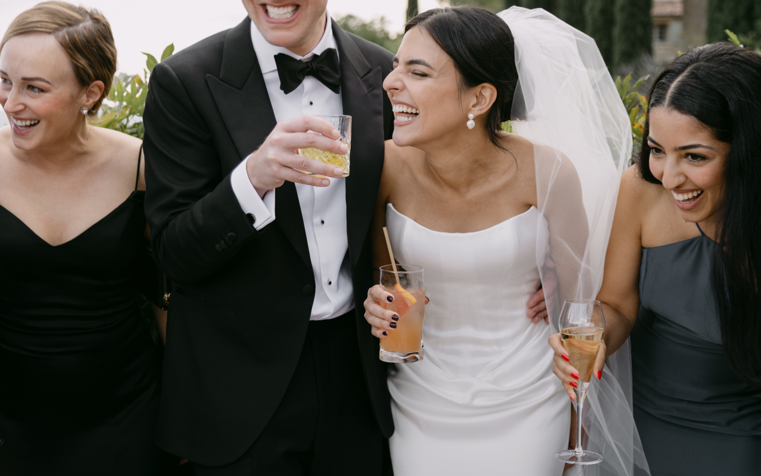 Newlywed couple laughing with their family on their wedding day. Elegant, timeless, and editorial wedding photography.